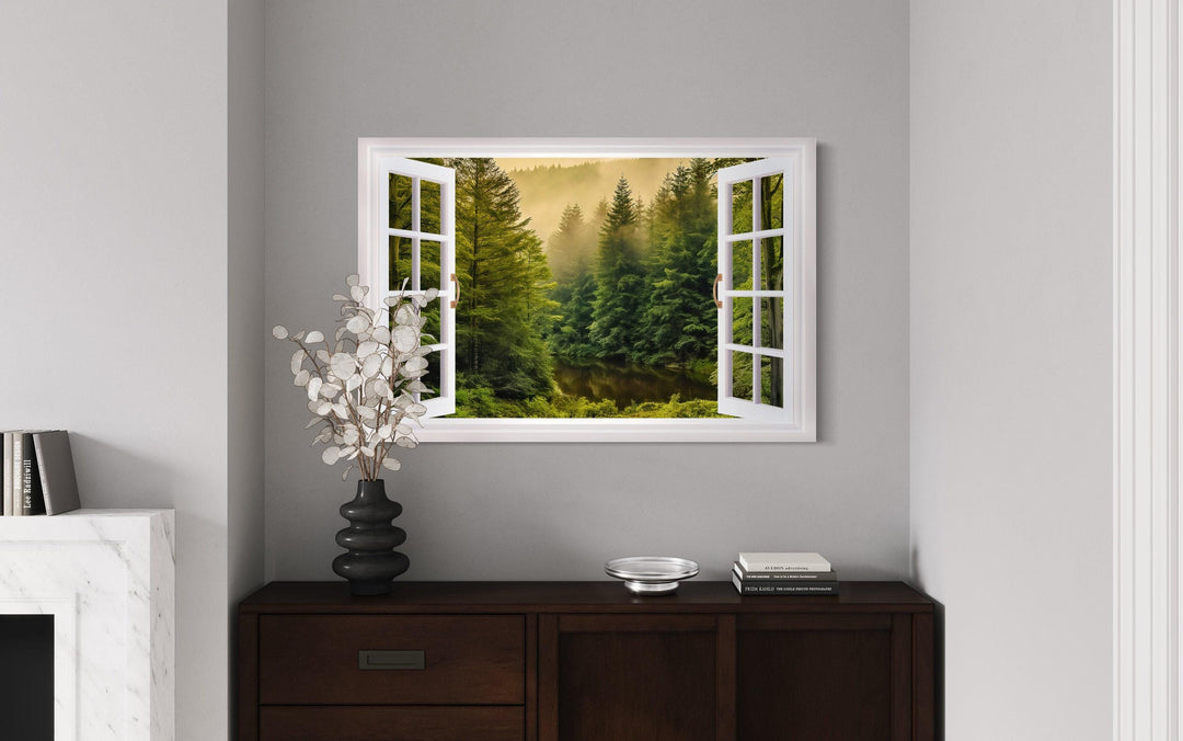 Fake window wall art showing a foggy pine forest with a stream through open white window frames.