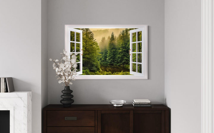 Fake window wall art showing a foggy pine forest with a stream through open white window frames.
