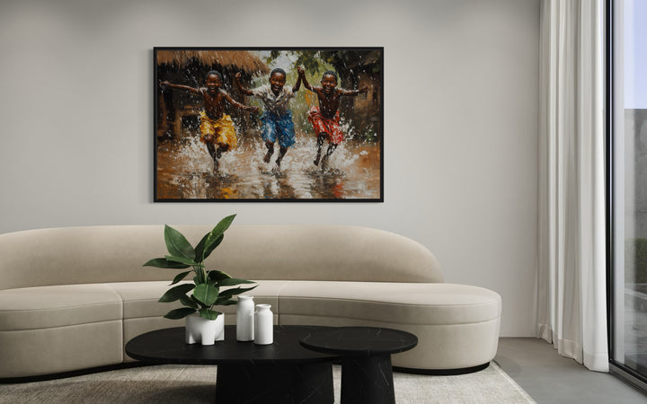 Happy African Boys Dancing In Rain Framed Canvas Wall Art in a living room with a couch