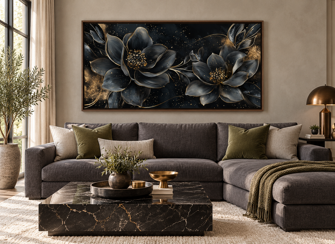 Black gold floral Art Nouveau framed canvas wall art hanging above a dark grey sectional sofa.