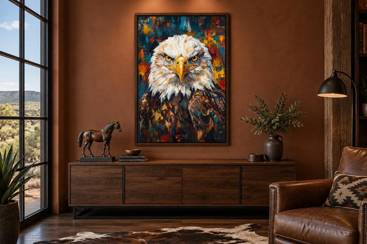 Bald eagle patriotic canvas wall art in a vertical frame above a wooden console in a men's office.