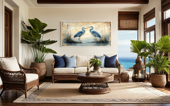 Rustic Blue Herons Horizontal Framed Canvas Wall Art in a coastal living room filled with furniture