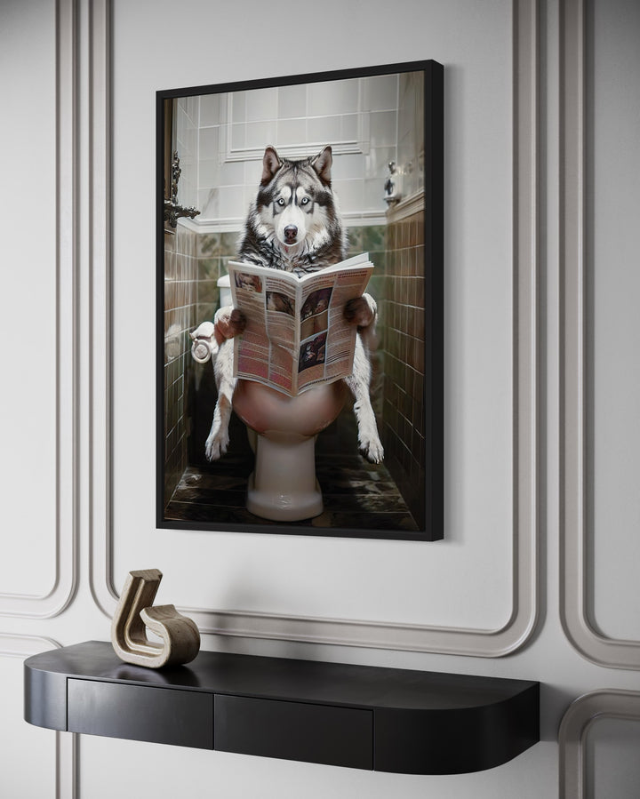 alaskan Husky sitting on a toilet reading a magazine