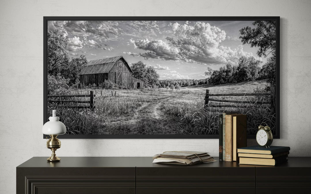 Black and white rustic barn landscape canvas wall art displayed above a dark wooden dresser.