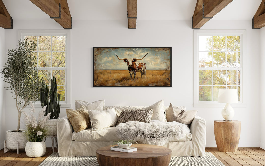 Longhorn in Open Prairie Rustic Farmhouse Canvas Wall Art above beige couch