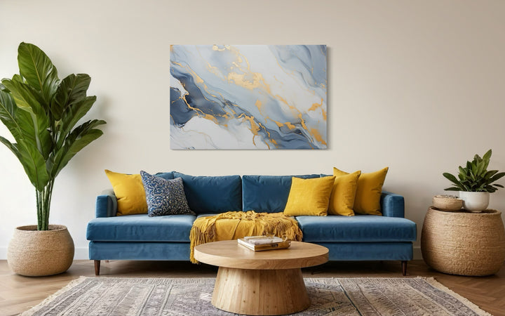 Pale Blue Grey Gold Abstract Marble Canvas Wall Art in a living room with a blue couch and yellow pillows