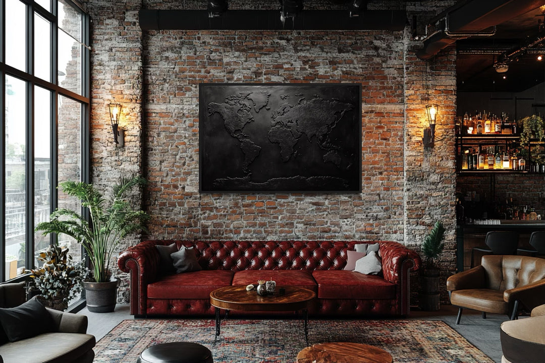 Black World Map Framed Canvas Wall Art in a living room filled with furniture and a brick wall