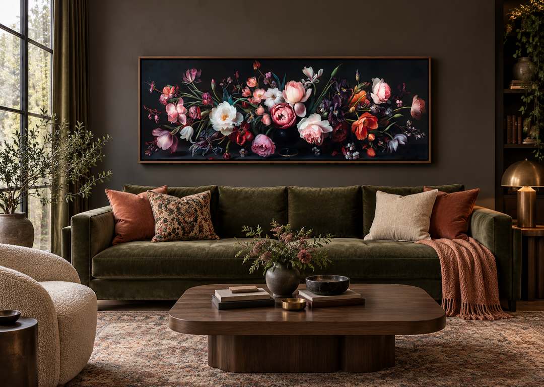 Moody dark flowers antique panoramic canvas wall art hanging above a green velvet couch.