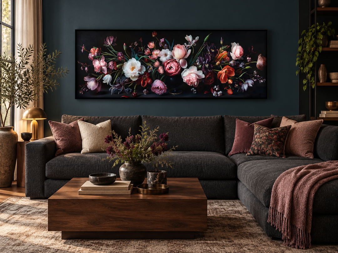 Panoramic wall art of moody dark flowers in a vintage style above a modern sectional couch.