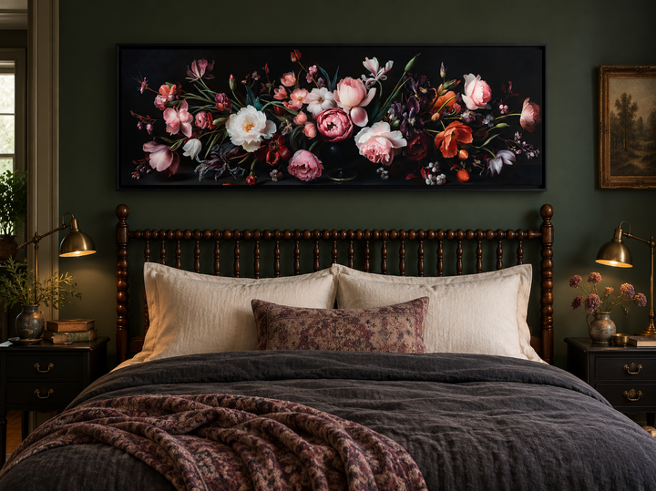 Panoramic wall art of moody dark flowers in a vintage style hanging above a bed in a dark room.