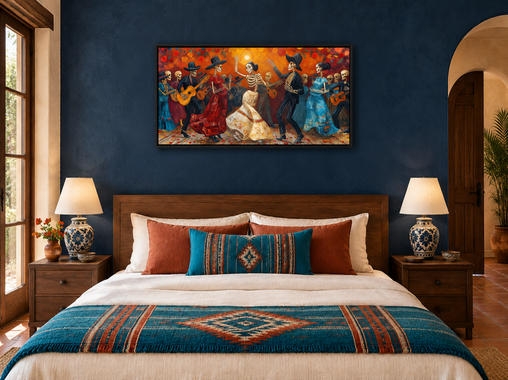Vibrant Dia De Los Muertos canvas art featuring dancing skeletons above a bed in a navy blue room.
