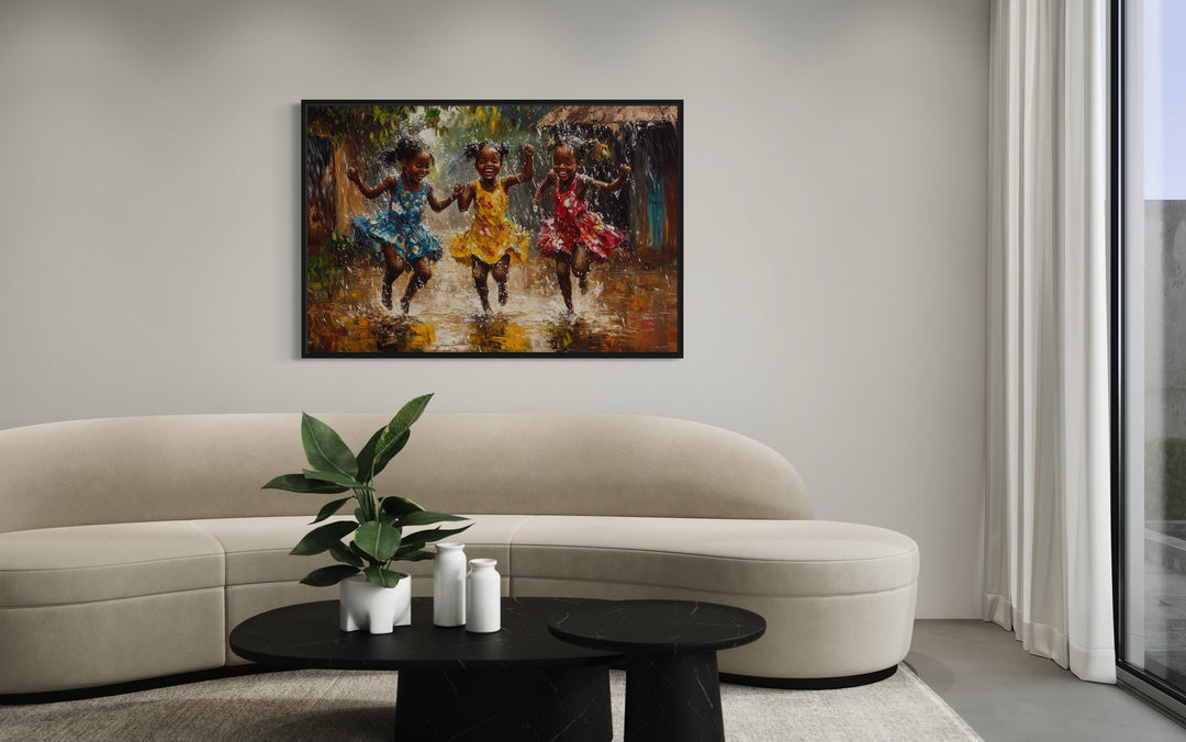 Happy African Girls Dancing In Rain Framed Canvas Wall Art in a living room with a couch