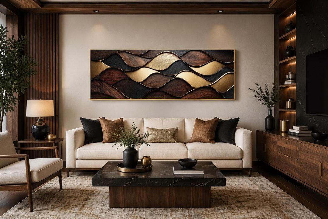 Long horizontal abstract canvas art with brown, black, and gold wood-grain wave patterns over a sofa