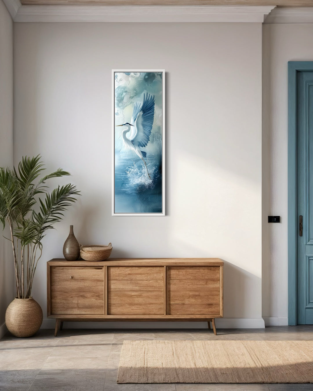 Tall Narrow Blue Heron In Flight Framed Vertical Canvas Wall Decor in a room with a blue door