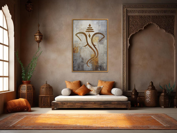 Minimalist gold Lord Ganesha canvas wall art in a warm, textured living room setting.
