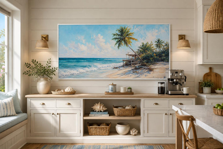 Tropical beach wall art with palm trees and turquoise waves above a white coastal sideboard.