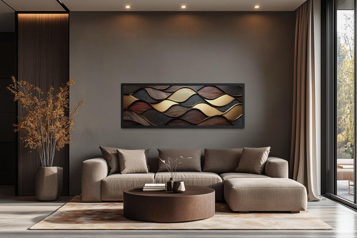 Long horizontal abstract wall art with brown and gold wood texture waves above a modern sofa.