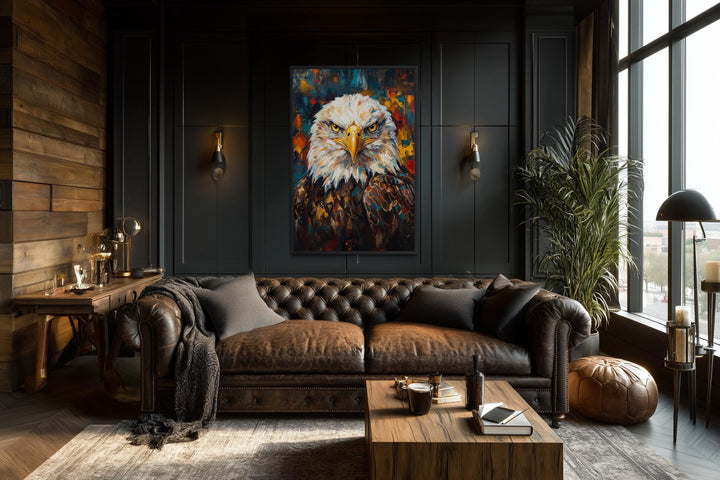 Bald eagle canvas wall art with colorful brushstrokes in a dark, modern office with a leather sofa.