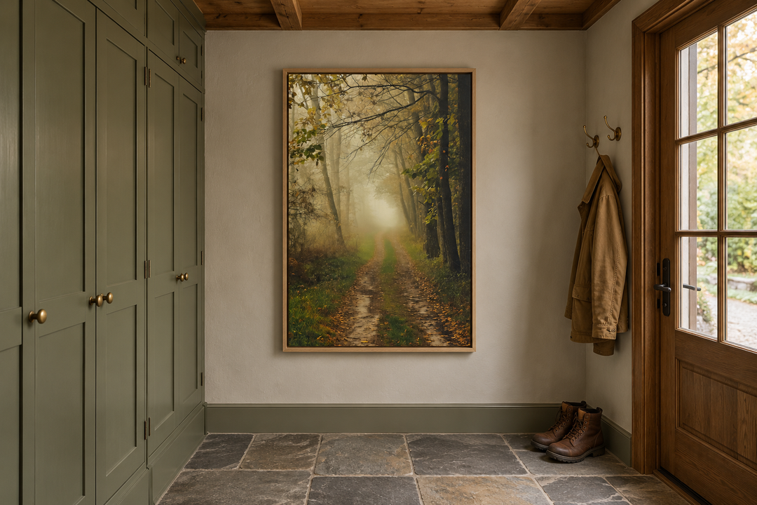 Moody foggy autumn forest framed canvas wall art hanging in a rustic mudroom with green cabinets.