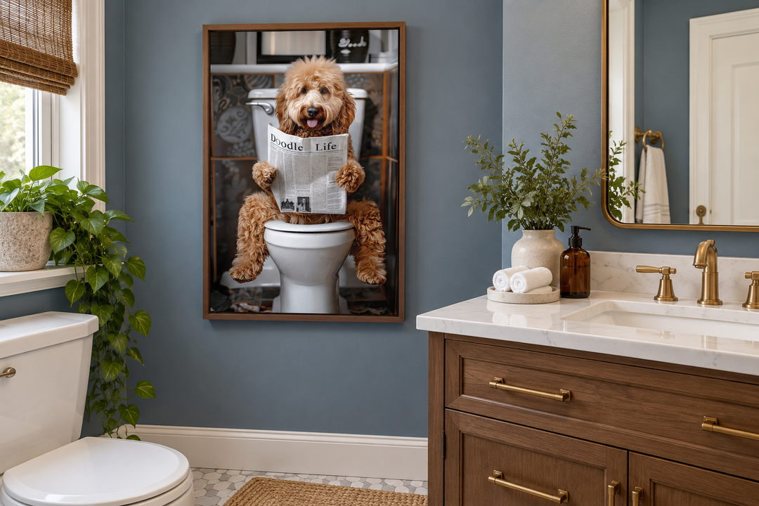 Framed canvas art of a Goldendoodle sitting on a toilet reading a newspaper in a blue bathroom.