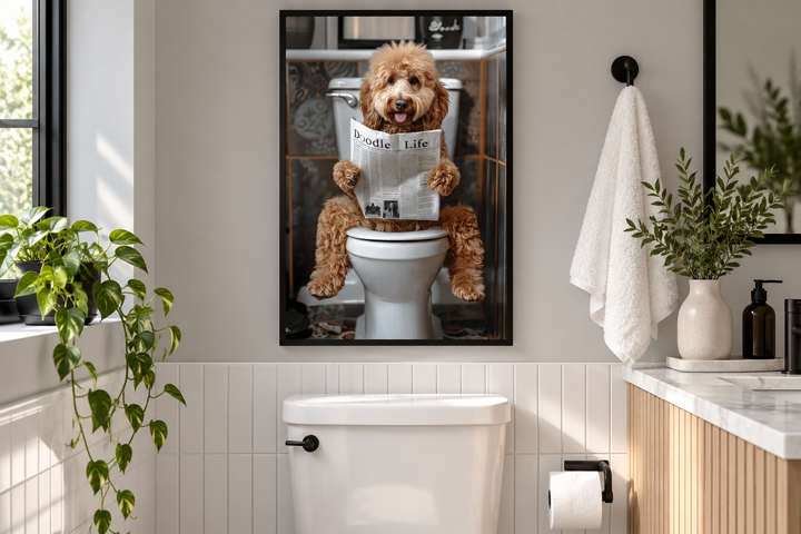 Framed canvas art of a Goldendoodle dog reading a newspaper while sitting on a toilet in a bathroom.