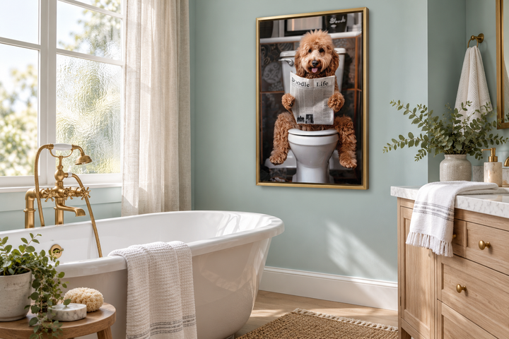 Goldendoodle on toilet reading newspaper framed canvas wall art in a seafoam green bathroom.