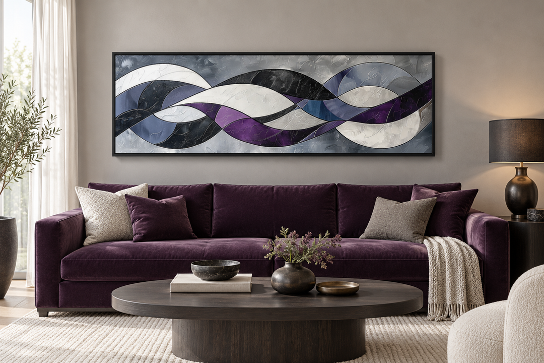 Purple, grey, and white geometric abstract panoramic canvas art in a black frame above a sofa.