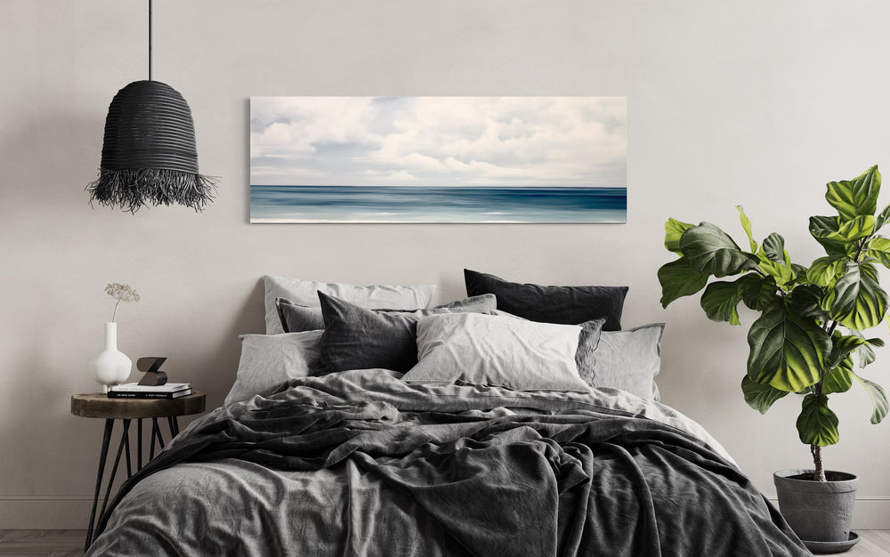 Calm Long Horizontal Ocean Above Bed Framed Canvas Wall Art above black bed