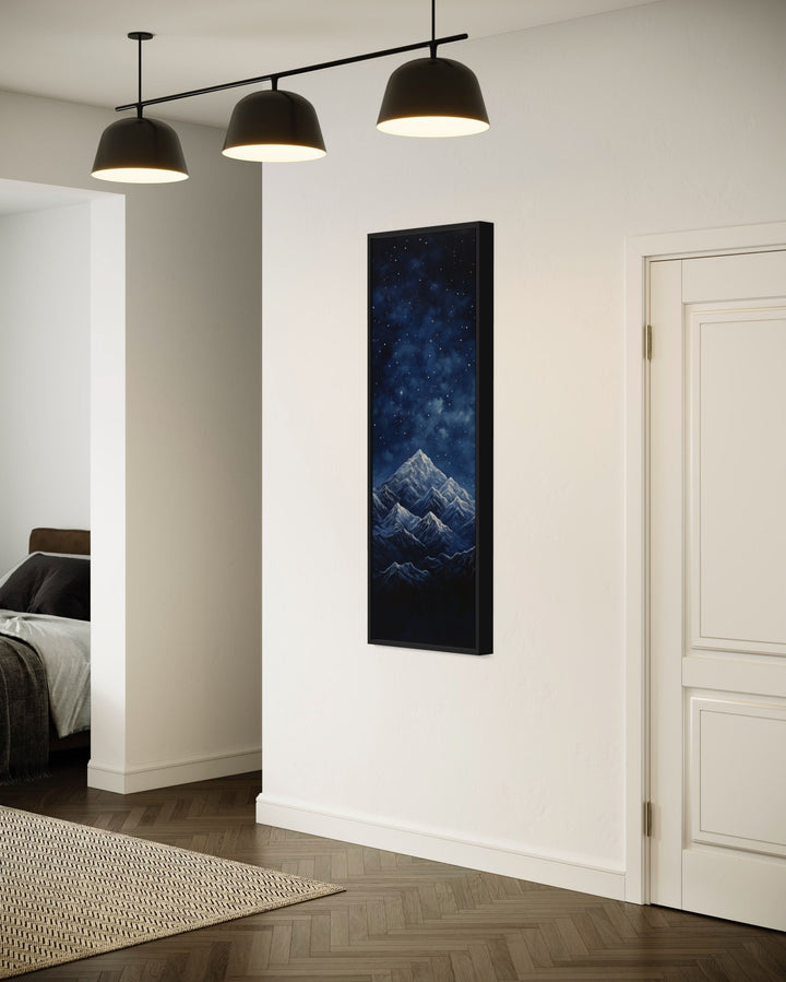 Tall Narrow Navy Blue Starry Night Over Mountains Vertical Framed Canvas Wall Art in living room side view