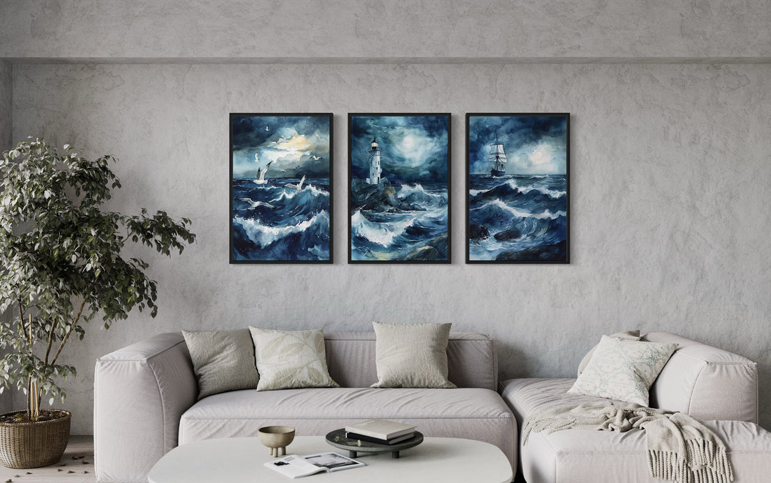 Set of 3 Lighthouse, Sail Ship, Seagulls In Stormy Ocean Nautical Framed Canvas Wall Art above grey couch