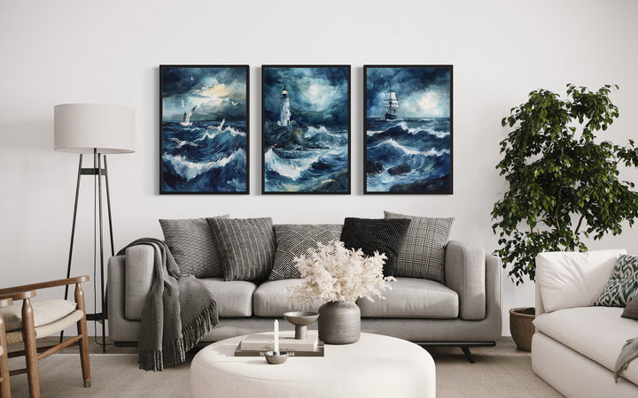 Set of 3 Lighthouse, Sail Ship, Seagulls In Stormy Ocean Nautical Framed Canvas Wall Art above grey couch