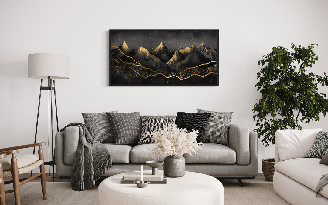 Black Gold Abstract Mountain Wall Art above grey couch