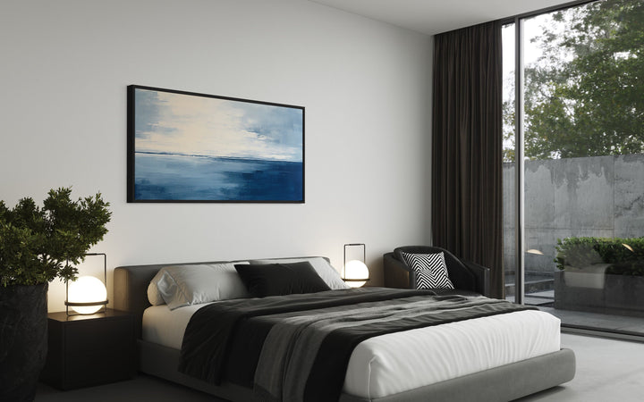 Abstract Ocean Navy Blue Grey Framed Canvas Wall Art above black bed