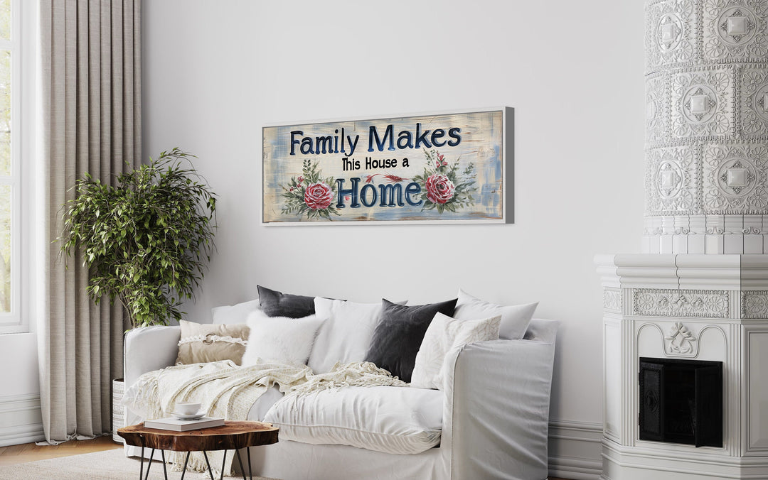 Family Makes This House A Home Sign Narrow Long Framed Canvas Wall Art above white couch