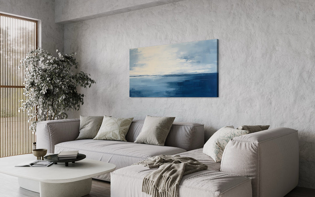 Abstract Ocean Navy Blue Grey Framed Canvas Wall Art above grey couch