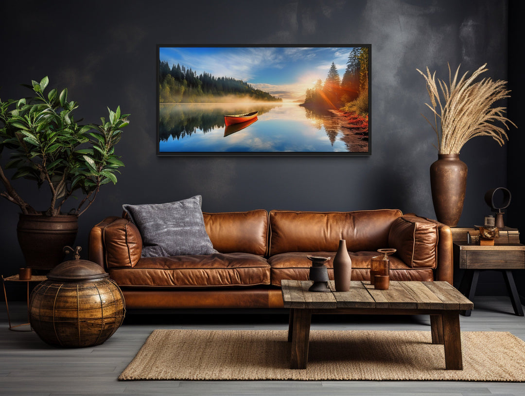 Lake With Red Canoe at Sunrise Framed Canvas Wall Art above brown couch