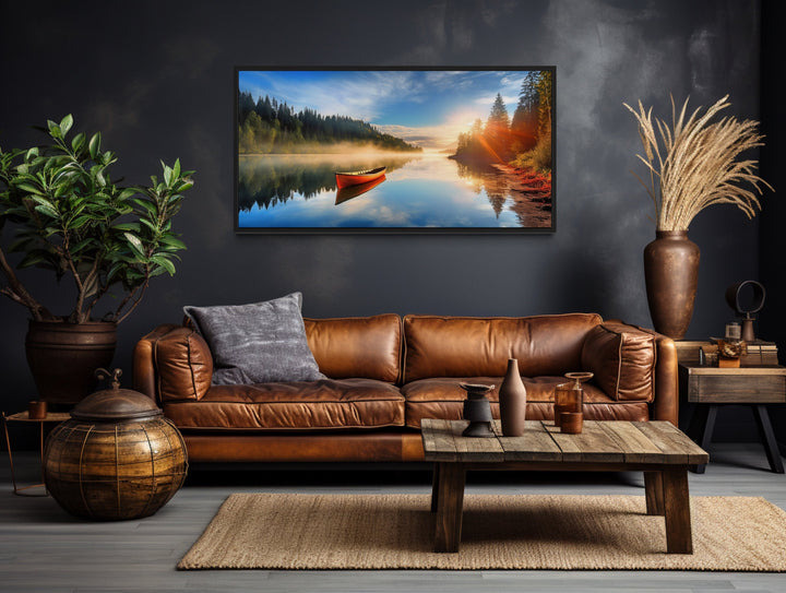 Lake With Red Canoe at Sunrise Framed Canvas Wall Art above brown couch