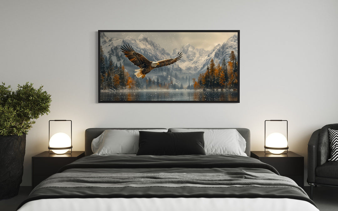 Bald Eagle Flying Over Snowy Mountain Lake Framed Canvas Wall Art above bed