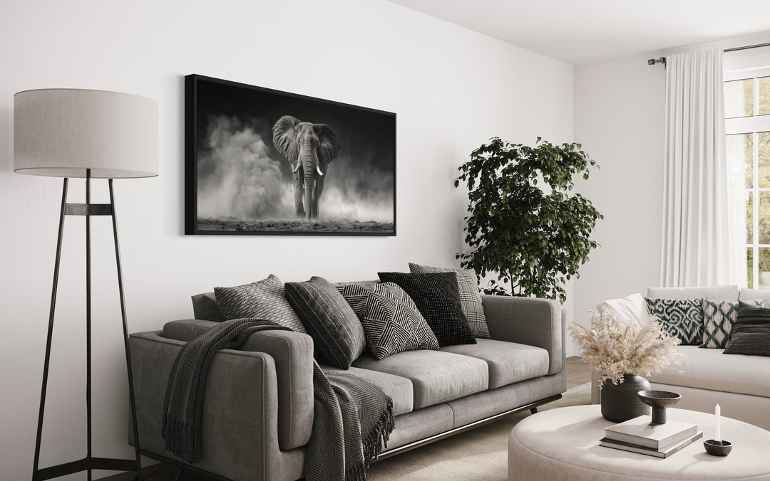 Elephant In Savanna Dust Black White Photography Framed Canvas Wall Art above couch
