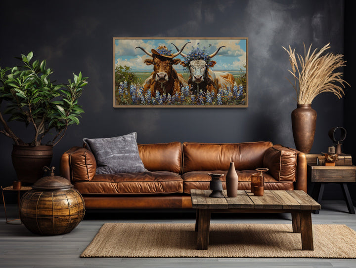 Two Texas Longhorns Cow And Bull Wall Art above brown couch