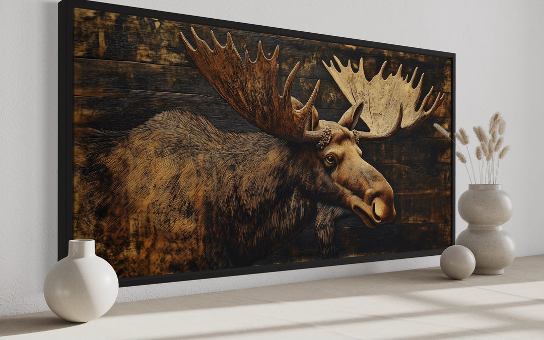 Moose Painted on Dark Wood Framed Canvas Wall Art in cabin side view