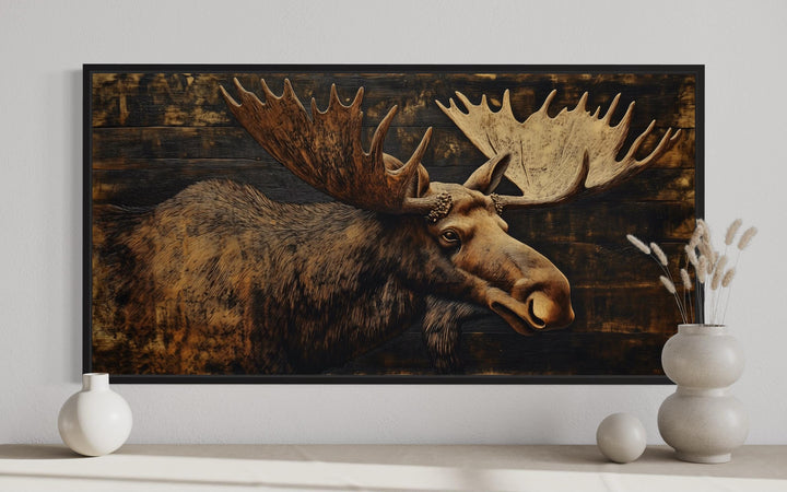 Moose Painted on Dark Wood Framed Canvas Wall Art in cabin close up