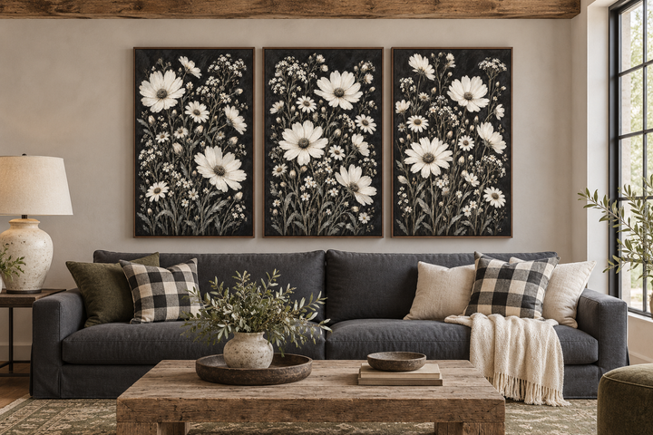 Set of 3 white wildflower canvas prints on black backgrounds in a rustic living room setting.