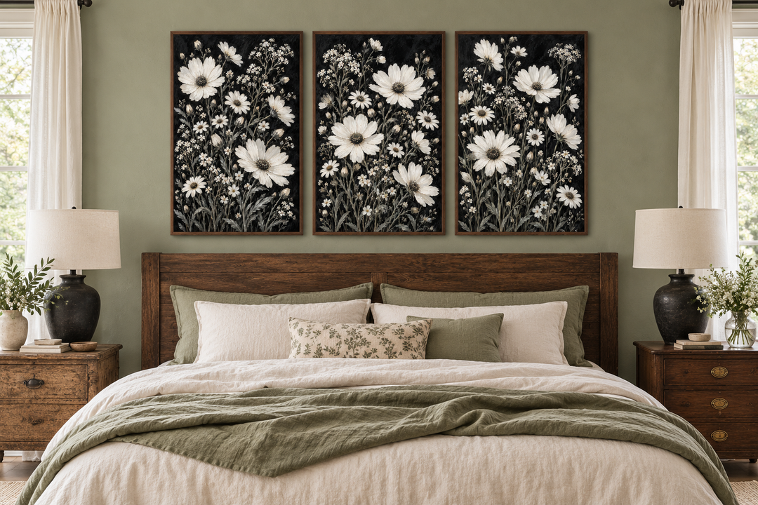 Set of 3 white wildflower canvas prints on black backgrounds above a rustic wooden bed frame.