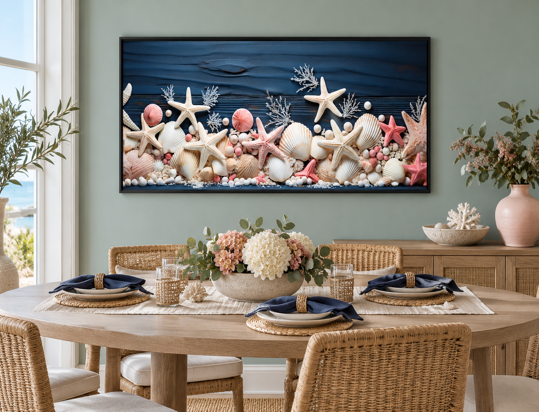 Coastal wall art with pink starfish and seashells on a navy blue wood texture in a black frame.