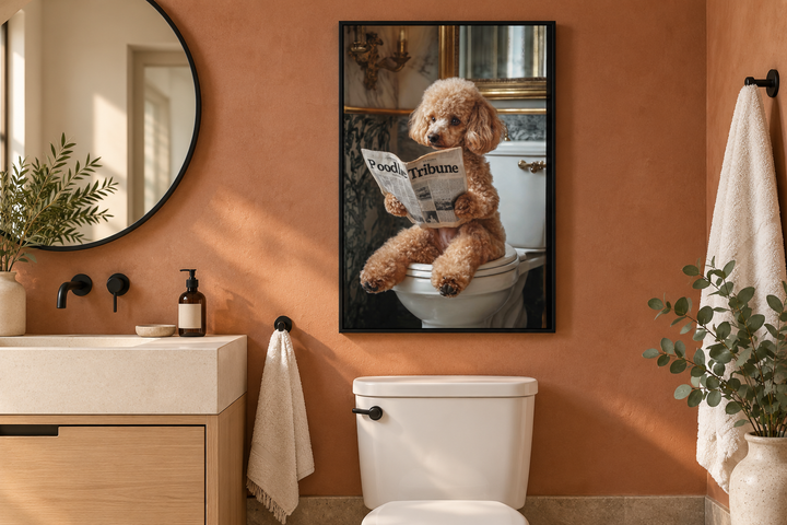 Framed canvas art of a peach poodle reading a newspaper on a toilet in a modern bathroom.