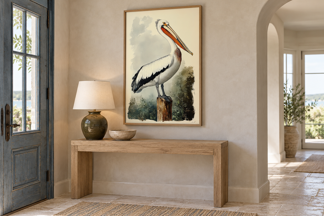Vintage Pelican Framed Canvas Wall Art in a vertical oak frame above a wooden console table.