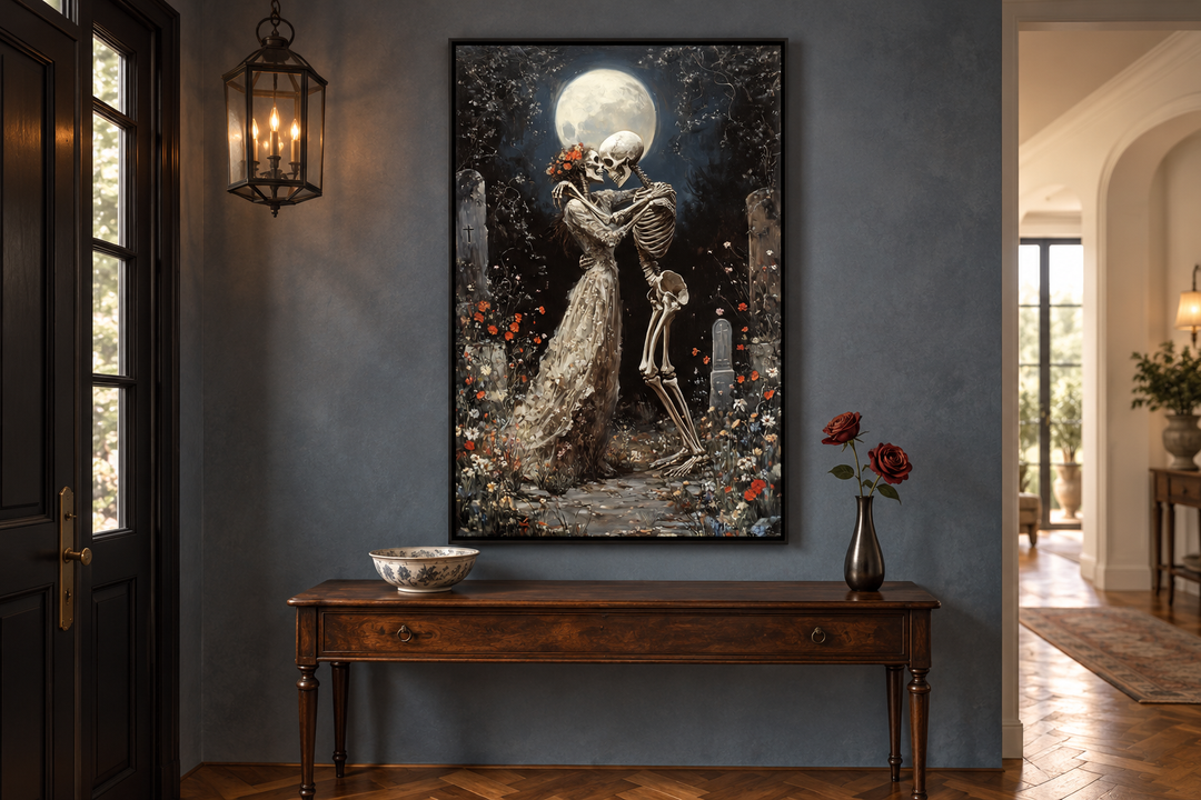 Gothic wall art of two skeletons dancing in a moonlit cemetery, framed above a wooden console table.