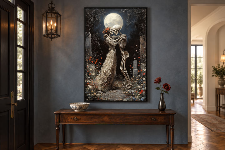 Gothic wall art of two skeletons dancing in a moonlit cemetery, framed above a wooden console table.