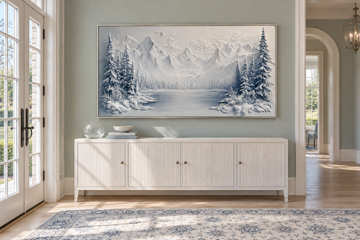 Snowy Mountain Lake With Pine Trees Winter Framed Canvas Wall Art above a white sideboard.
